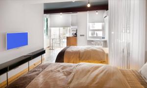a bedroom with two beds and a tv on a wall at Nuru Ziya Residences in Istanbul