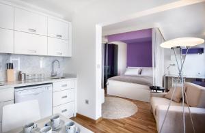 a kitchen and living room with a couch and a bed at Nuru Ziya Residences in Istanbul
