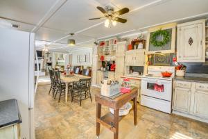 a kitchen with a table and a ceiling fan at Home with Ouachita River and Lake Hamilton Access in Mountain Pine