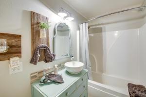 a bathroom with a sink and a mirror on a dresser at Home with Ouachita River and Lake Hamilton Access in Mountain Pine +23 photos