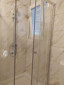 a bathroom with a shower with a glass door at Apartmani Dubravka in Rab +31 photos