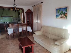 a living room with a couch and a table at Matalascañas MAR in Matalascañas