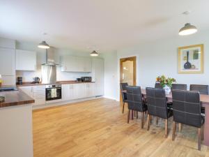 a kitchen and dining room with a table and chairs at The Barn, Drumbow Farm in Airdrie