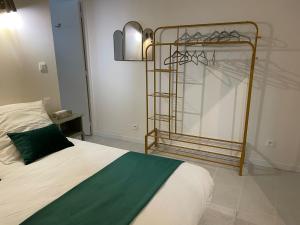 a bedroom with a bed and a metal closet at Les Moulins Saint Antoine in Loches