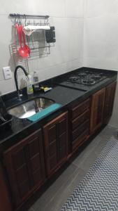 a kitchen with a sink and a stove at Casa da Duna in Aracati