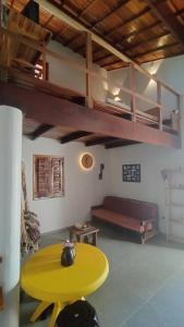 a living room with a yellow table and a couch at Casa da Duna in Aracati