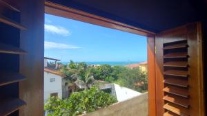 a view of the ocean from a window at Casa da Duna in Aracati