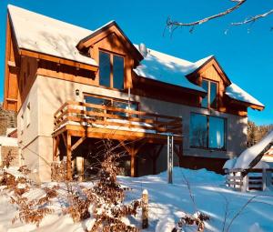 a house in the snow with snow at Apartmány Kunc in Bedřichov