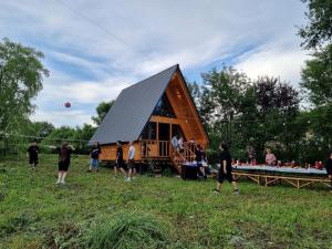 a group of people standing around a tiny house at Koxta in Akhaliki