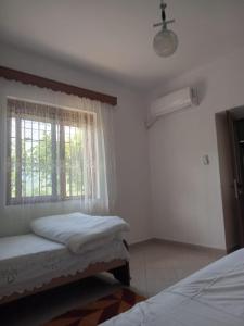 Ένα ή περισσότερα κρεβάτια σε δωμάτιο στο Desao Apartment +1 φωτογραφίες