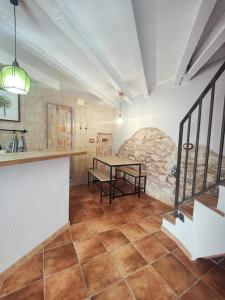 a kitchen with a table in the middle of a room at Ca la Marta in Santa Liña