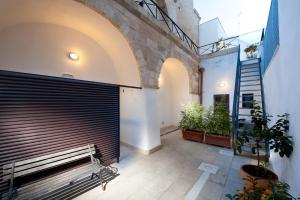 a bench in a hallway with a staircase and a building at B&B Residenza Pizziniaco in Lecce