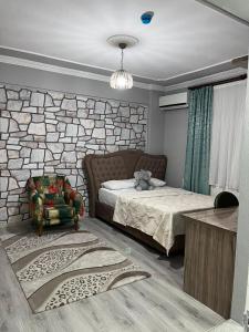 a bedroom with a bed and a stone wall at YALI Suit HOTEL in Trabzon +163 photos