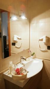 a bathroom with a sink and a mirror at Catia Sweet Holiday 2 in Fiumicino +25 photos