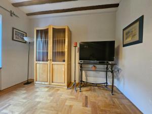 a living room with a flat screen tv and a table at Saint George Apartment in Split +3 photos
