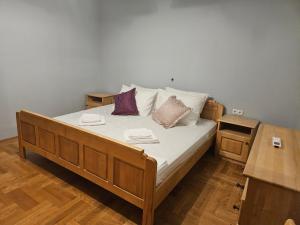 a bedroom with a bed with pillows on it at Saint George Apartment in Split