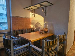 a wooden table and chairs in a room with a window at Saint George Apartment in Split