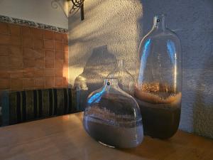 two glass vases sitting on top of a table at Saint George Apartment in Split