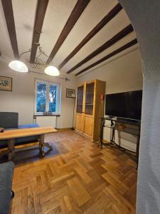a living room with a table and a flat screen tv at Saint George Apartment in Split