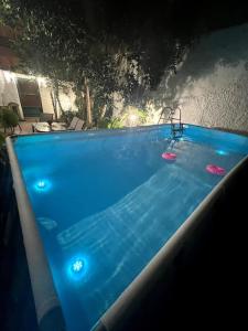 a large blue swimming pool with four frisbees in it at Oasis Pool Flat-near 2 metro stations- in Piraeus