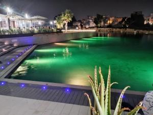 a swimming pool at night with green water at Domus Vetriera in Palermo
