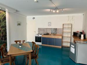 a kitchen with blue floors and a table and chairs at Pension NentersHaus in Nentershausen +38 photos