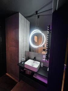 a bathroom with a sink and a mirror at BeDS&More in Wrocław
