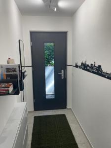 a blue door in a kitchen with a window at Ferienwohnung-neu renoviert-nahe Regensburg in Bad Abbach +11 photos