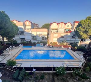 a large swimming pool in front of a building at L'appart D79 in Gruissan