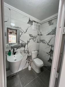 a bathroom with a toilet and a sink at YALı APART HOTEL in Trabzon +160 photos