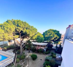 an aerial view of a resort with a pool and trees at L'appart D79 in Gruissan