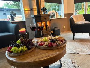 a table with two plates of food and wine at Chalet Harmony Lux Privé Wellness in Putten