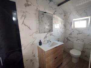 a bathroom with a sink and a toilet at Kataenea. Apartamento en el prepirineo navarro. Naturaleza in Aoiz +23 photos