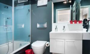 a bathroom with a toilet and a shower and a sink at Nuru Ziya Residences in Istanbul