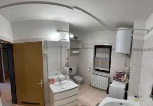 a bathroom with a sink and a toilet at Apartments Stella in Piran +29 photos