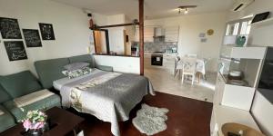 a living room with a bed and a kitchen at Apartments Stella in Piran