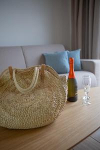 a straw bag sitting on a table with a wine bottle at NOIMA Casa Unico in Megalochori