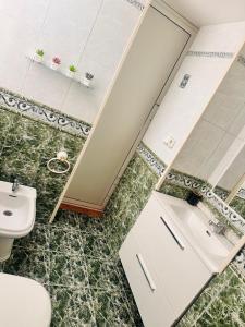 a bathroom with a toilet and a sink at Campos vasallo in Alicante +11 photos