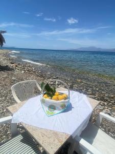 un panier de fruits sur une table à la plage dans l'établissement Paradise house, à Kato Alepochori