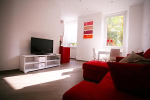 Televízia a/alebo spoločenská miestnosť v ubytovaní Red Flat In Rome