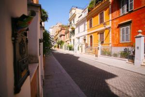 an empty street in a city with buildings at Red Flat In Rome in Rome