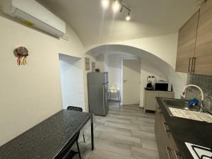 a kitchen with a sink and a refrigerator at Meghan Home in Catania