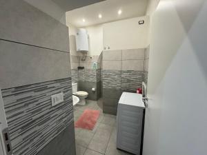 a bathroom with a shower and a toilet and a sink at Meghan Home in Catania