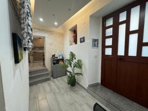 a hallway with a door and a potted plant at Meghan Home in Catania +19 photos
