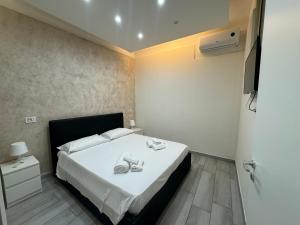 a bedroom with a bed with shoes on it at Meghan Home in Catania