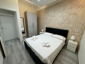 a bedroom with a large bed with towels on it at Meghan Home in Catania
