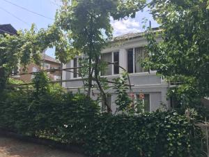 a white house with trees in front of it at Anna's Guesthouse in Kobuleti