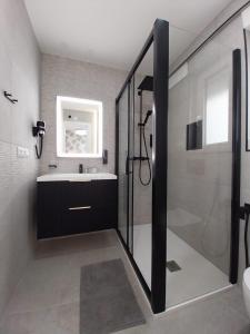 a bathroom with a shower and a sink at Gandia Playa Apartament Claudia Lux con vistas al mar in Playa de Gandia +18 photos
