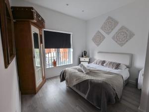 a bedroom with a bed and a large window at The boot factory in Leicester