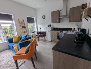 a kitchen and living room with a blue couch at The boot factory in Leicester